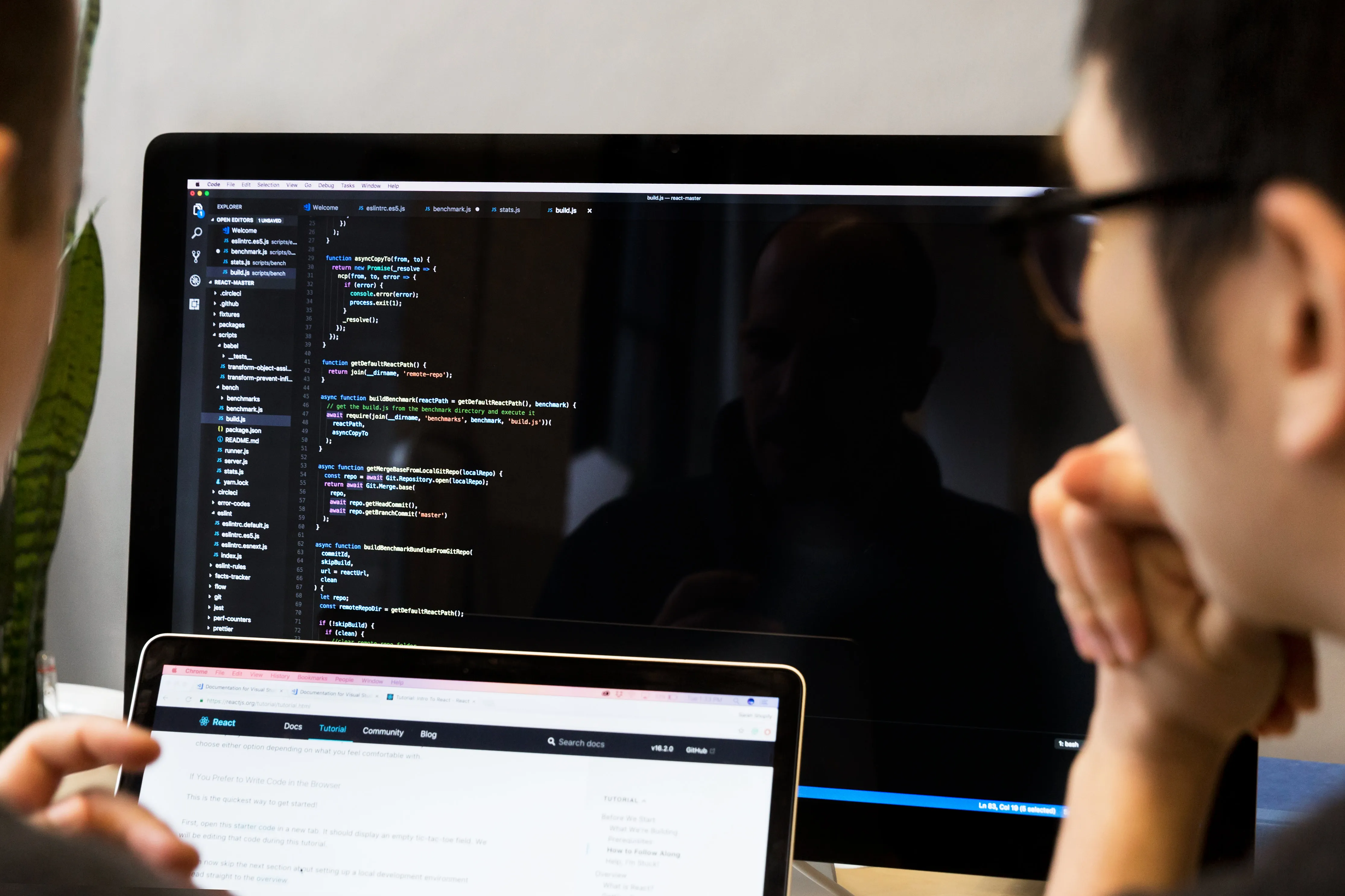 A developer is closely reviewing his colleague's Javascript code.